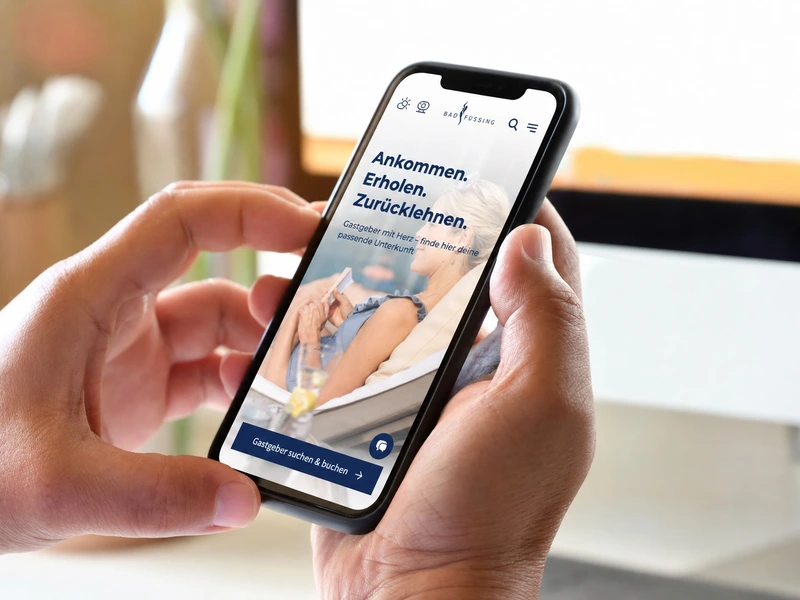 Mobile view of the Bad Füssing website on a smartphone, with access to the accommodation search.
